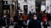Pedestrians walk along a shopping street in Vienna, Austria, November 17, 2021. 