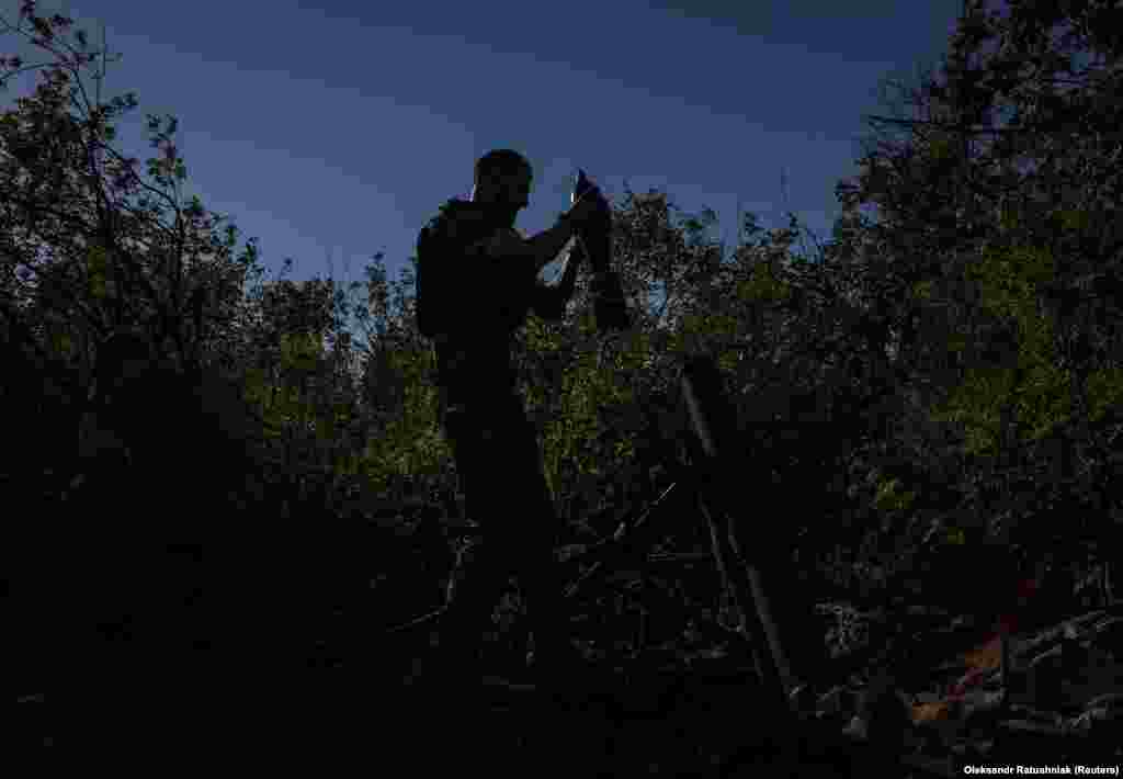 A Ukrainian soldier prepares to fire a mortar onto Russian positions near the city of Bakhmut on August 7. &nbsp;
