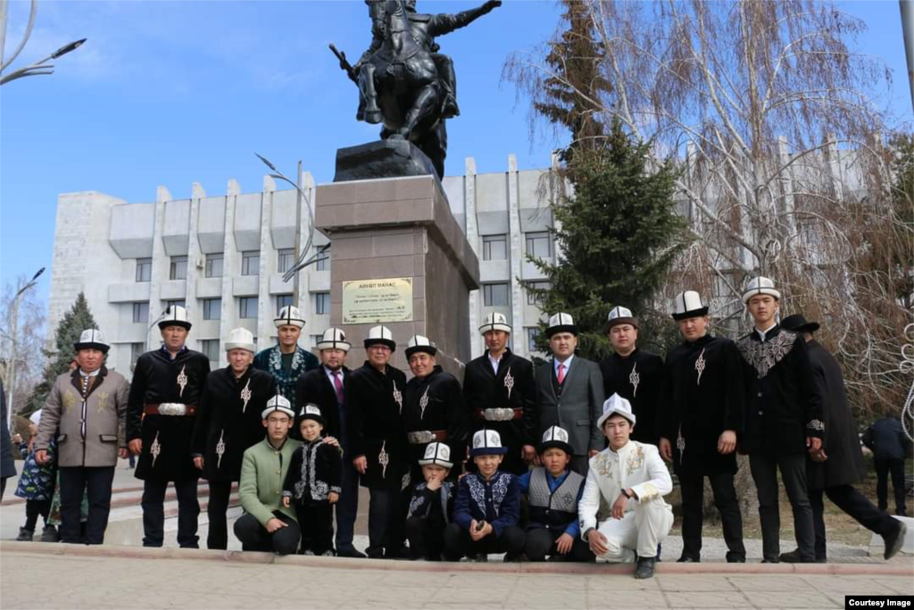 Манасчылар Таластагы Манастын жаңы орнотулган эстелигинин жанында турушат.&nbsp;