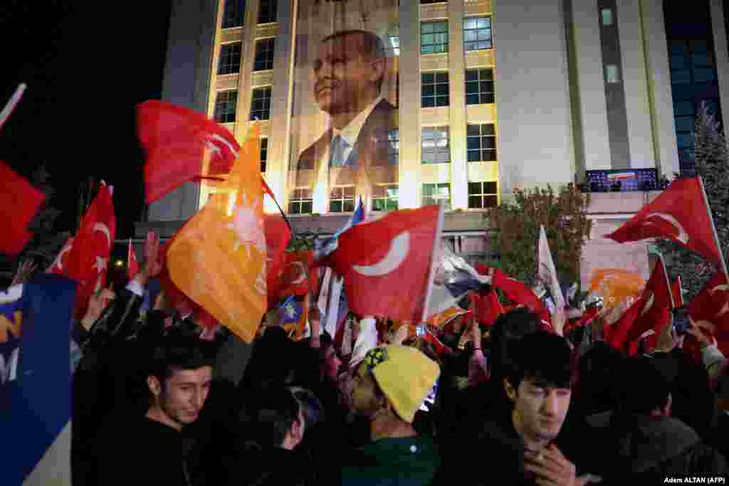 Erdoğan támogatói zászlókat lengetnek az AK párt székháza előtt urnazárás után. Az eddigi eredmények szerint sem Erdoğan, sem Kılıçdaroğlu nem érte el a május 28-án esedékes második forduló elkerüléséhez szükséges ötvenszázalékos küszöböt