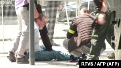 Az AFPTV által megszerzett videófelvételről készült képen látható, amint a biztonságiak elfogják a feltételezett támadót Nyitrabányán 2024. május 15-én