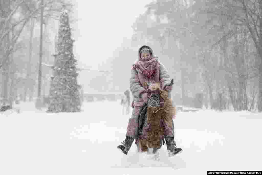 Žena jaše ponija u parku tokom velikih snježnih padavina u Moskvi.
