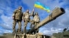 U.K. – Ukrainian personnel hold a Ukrainian flag as they pose on top of a Challenger 2 tank during training at Bovington Camp, near Wool in southwestern Britain, February 22, 2023