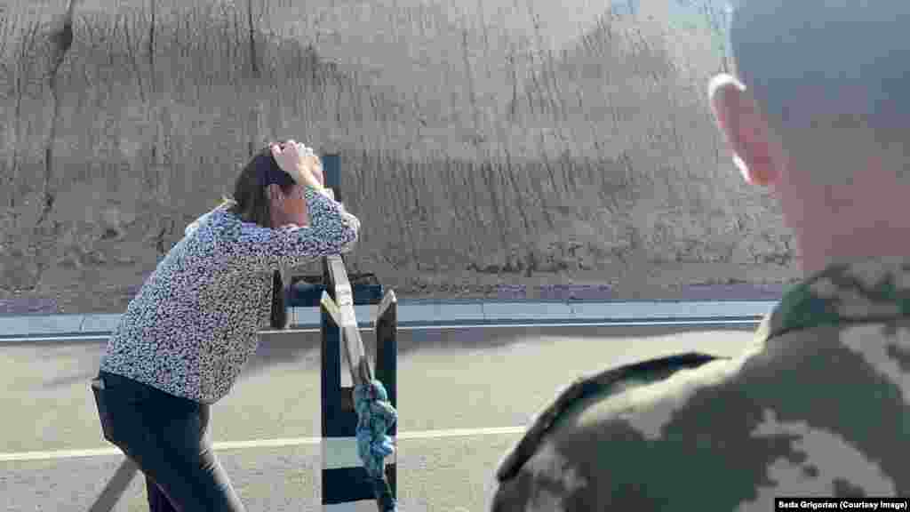 A woman looks in the direction of Nagorno-Karabakh from a checkpoint near the southern Armenian village of Kornidzor on July 23.&nbsp; In a recent interview, Armenia&#39;s Prime Minister Nikol Pashinian likened the Nagorno-Karabakh blockade to an ethnic &quot;ghetto&quot; of the kind created by Nazi forces during World War II. Azerbaijani President Ilham Aliyev, in a recent address, said that if Armenia &quot;completely renounces any kind of encroachment on the territory of Azerbaijan,&quot; a peace treaty will be possible before the end of 2023.&nbsp;