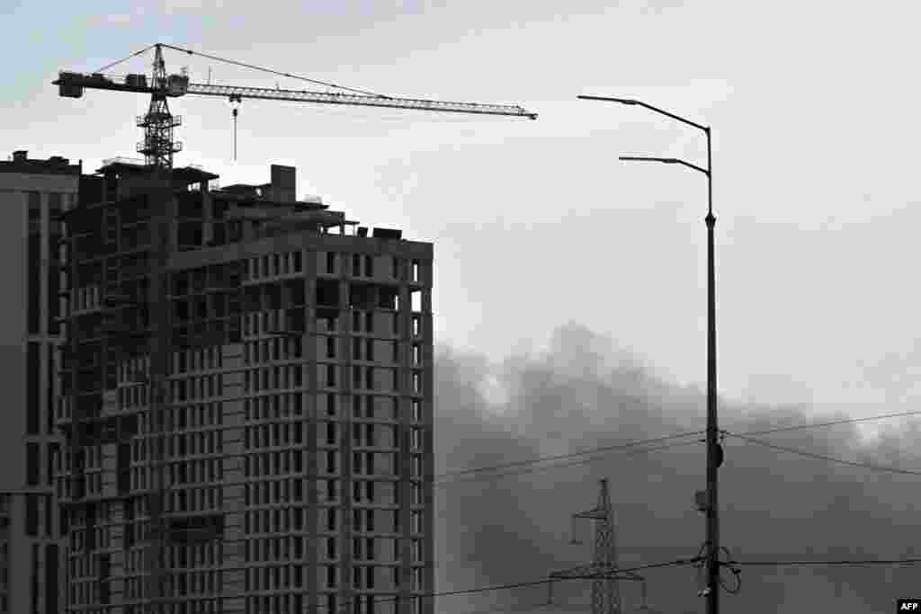 Smoke billows from a Russian missile strike in Kyiv.&nbsp;At least two people were injured in a strike on Kyiv&#39;s Sviatoshyn district, Mayor Vitali Klitschko wrote on Telegram.