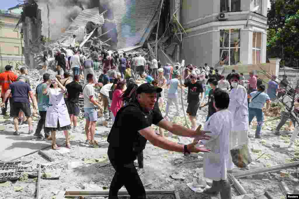 Люди, врачи и спасатели разбирают завалы одного из корпусов детской больницы &quot;Охматдет&quot; в Киеве, по которой российская армия нанесла удар, 8 июля 2024 года.