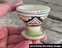 Kupë prej balte e zbukuruar me motive kombëtare.