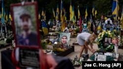 Natalya Zaichenko, 60, tends to the grave of her son, a Ukrainian soldier who was killed in the war against Russia, in Kyiv on August 3.