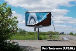 Radnici postavljaju novi poster na ulazu u nekadašnji logor ALŽIR