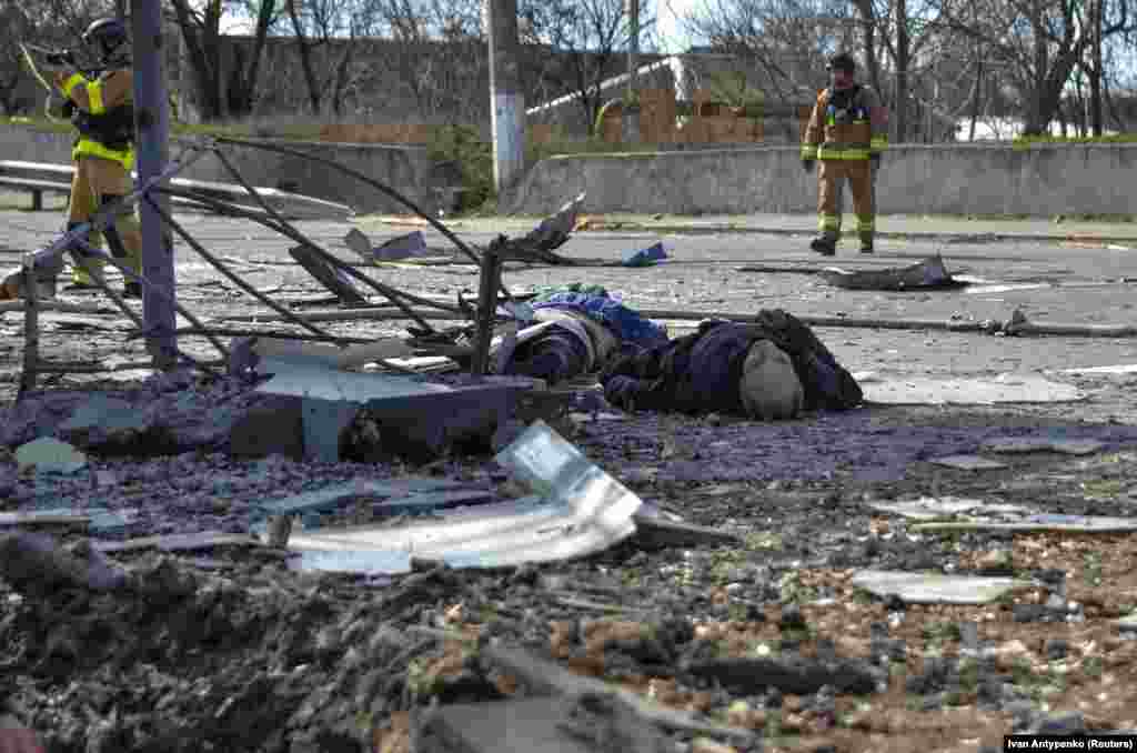 The bodies of people killed by a Russian strike are seen at a public-transport stop in Kherson.