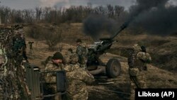 Ukrainian soldiers fire a howitzer toward Russian positions near Bakhmut in the eastern Donetsk region on March 7.