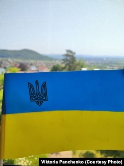 Український стяг, який вдалося вивезти з окупації батьку Вікторії, майорить на вікні німецької квартири Панченків