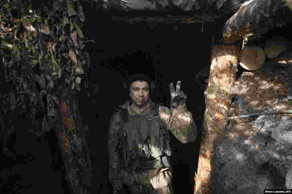Ukrajinski vojnik pokazuje znak pobede iz svog rovovskog položaja blizu Kliščijivke. Kijev se zavetovao da će osloboditi sve teritorije koje je okupirala Rusija, uključujući poluostrvo Krim, koje je Kremlj nezakonito anektirao 2014. godine.