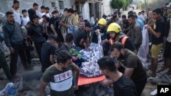 Palestinci nose osobu ranjenu u zračnim napadima u Khan Younisu, Pojas Gaze, 16. oktobra 2023.