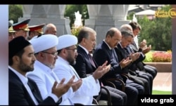 Mufti Nuriddin Kholiqnazarov (from 3rd left to right), President Shavkat Mirziyoev, and Prime Minister Abdulla Aripov pray during a public appearance in Tashkent on August 31.
