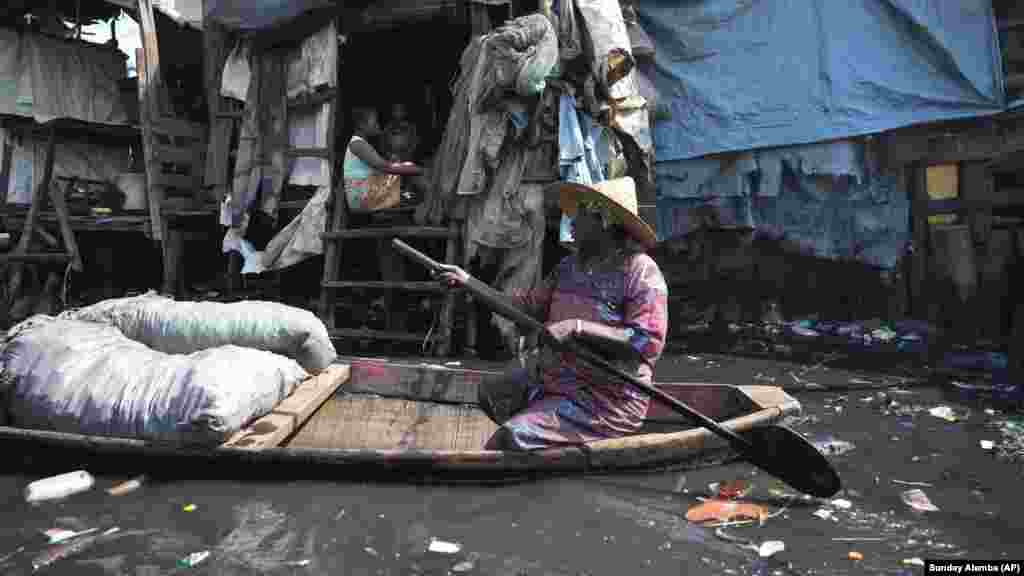 Egy nő evez a szemét között a nigériai Lagos nyomornegyedében 2023. március 20-án.&nbsp;Az ENSZ adatai szerint több százmillió ember számára nem hozzáférhető a tiszta ivóvíz.&nbsp;Az előrejelzések szerint a vízhiánnyal küzdők száma a 2016-os 930 millióról 2050-re 1,7-2,4 milliárd főre, azaz a duplájára nőhet