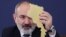 Armenia - Prime Minister Nikol Pashinian holds a cardboard cutout of Armenia's map at a news conference in Yerevan, March 12, 2024,