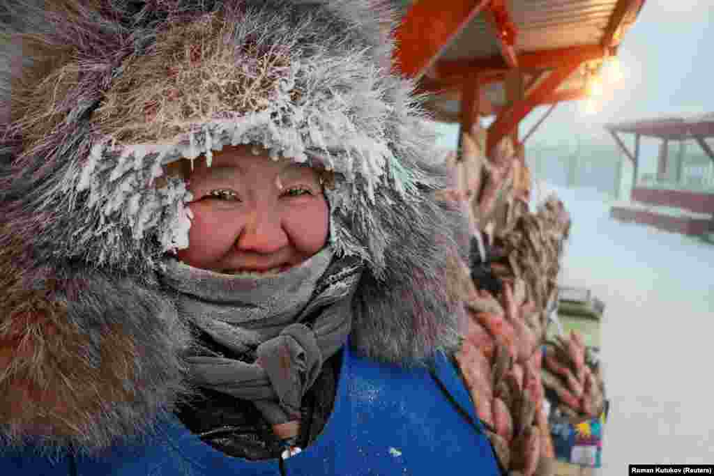 Prodavačica Nyurgusun Starostina (47) pozira za fotografiju na pijaci na otvorenom tokom mraznog dana u Jakutsku u Rusiji.