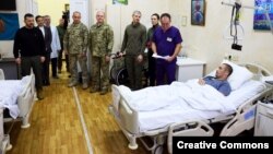 Ukrainian President Volodymyr Zelenskiy (left) visits wounded soldiers at a hospital in Kyiv on December 6.