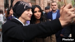 A young fan takes a selfie with Kim Kardashian during her visit to Yerevan in 2015. 