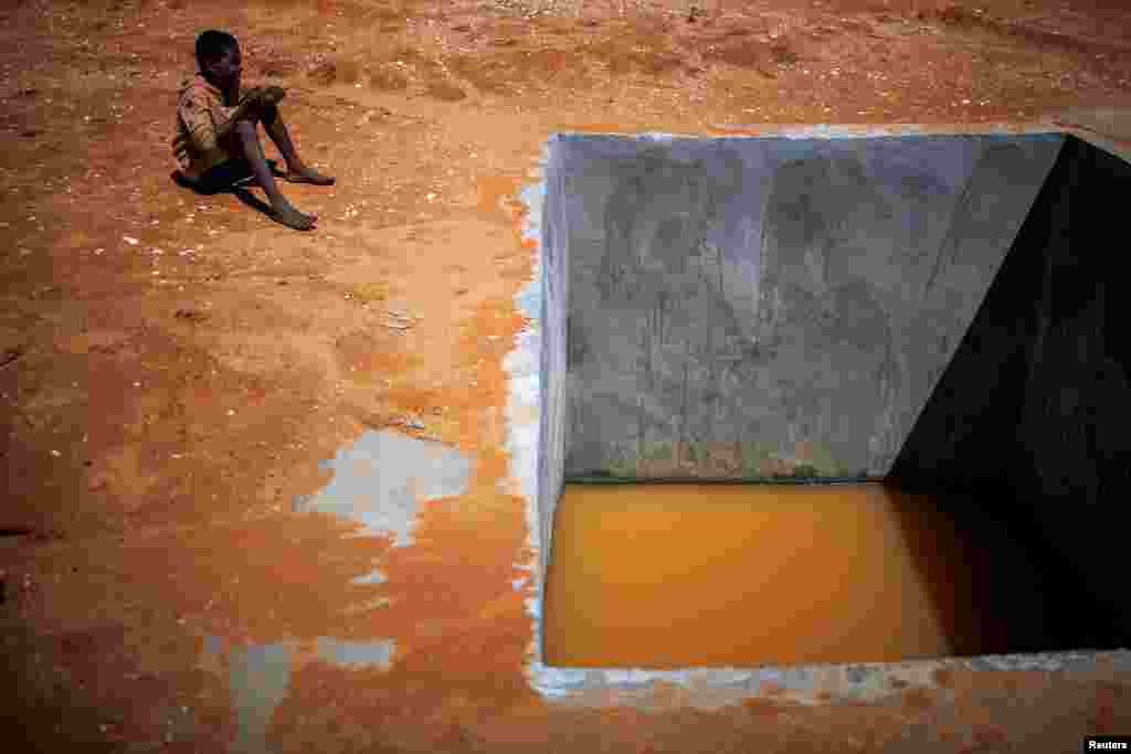Egy kisfiú egy vörös színű vízzel félig teli kút mellett. A négy éve tartó erdőirtások és a fokozódó szárazság miatt egyre súlyosabb az elsivatagosodás Madagaszkáron