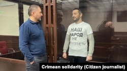 Imam Raif Fevziyev stands behind glass during the announcement of the verdict in the Southern District Military Court of Rostov-on-Don on January 12.