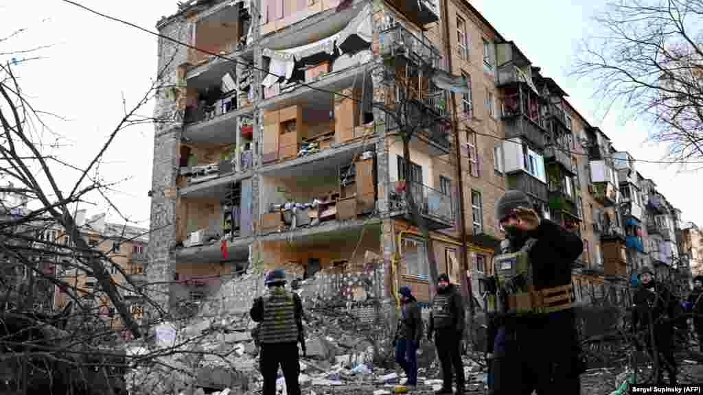 UKRAINE -- Ukrainian policemen secure the area by a five-storey residential building