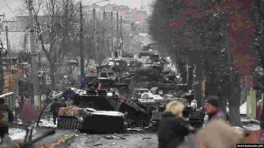 Ukraine -- People look at the gutted remains of Russian military vehicles