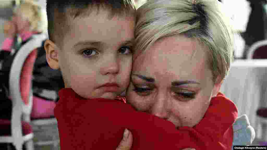 Ukraine -- Egor, 5, comforts his mother Helen Yakubets