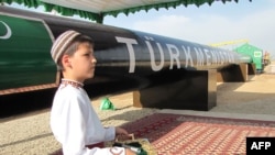 A Turkmen boy at an official launch ceremony for the East-West gas trunk pipeline in Shatlyk on May 31, 2010.