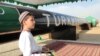 File photo of a Turkmen boy in traditional dress at an official launch ceremony of a gas pipeline project in 2010.