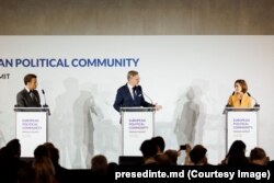 Maia Sandu, la conferința de presă după prima zi a summitului CPE, de la Praga, alături de președintele francez Emmanuel Macron (stânga), și de premierul țării-gazdă a primului summit CPE, Petr Fiala (centru).