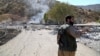 A Kurdish peshmerga fighter inspects the damage following an Iranian cross-border attack in the area of Zargwez, where several exiled left-wing Iranian Kurdish parties maintain offices, on September 28.