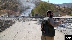 A Kurdish peshmerga fighter inspects the damage following an Iranian cross-border attack in the area of Zargwez, where several exiled left-wing Iranian Kurdish parties maintain offices, on September 28.