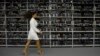 A woman walks past machines for the production of bitcoins during a presentation of the largest cryptocurrency center in Russia, Kriptoyunivers, in 2018.
