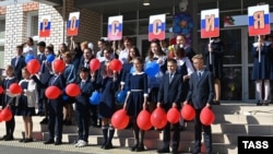 Students attend a Knowledge Day ceremony marking the beginning of the new school year at a school in the Siberian village of Verkh-Chita on September 1, 2022.