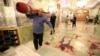 Workers clean up the scene of a deadly armed attack at the Shah Cheragh mausoleum in the Iranian city of Shiraz on October 26.