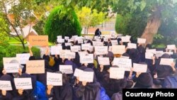 Students at Iran's Al-Zahra University take part in a sit-in protest on October 31 against the suspension of fellow students for taking part in protests that have spread across the country. 