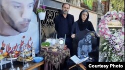 Pejman Gholipur's parents at his grave. "Tell us who killed our children.... We lost our loved ones in our own homeland," his mother told an international people's tribunal.