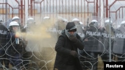 Польський правоохоронець застосував сльозогінний газ під час спроби мігрантів перетнути білорусько-польський кордон у пункті пропуску «Брузги-Кузниця», 16 листопада 2021 року 