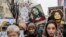 Kosovo -- Women hold posters as they take part in a march for women's rights and freedom in solidarity with the march organised in Washington, on January 21, 2017 in Pristina. Hundreds of thousands of protesters spearheaded by women's rights groups are 
