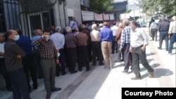 Retired people gather for a protest in Kermanshah on June 26.