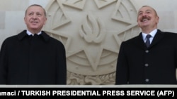 Turkish President Recep Tayyip Erdogan (left) and Azerbaijani President Ilham Aliyev attending a military parade in Baku on December 10