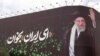 This picture shows a billboard bearing the portrait of Iranian supreme leader Ayatollah Ali Khamenei and a quote reads in Persian 'Sing Oh Iran' at the Enqelab Square in Tehran on July, 9, 2025.