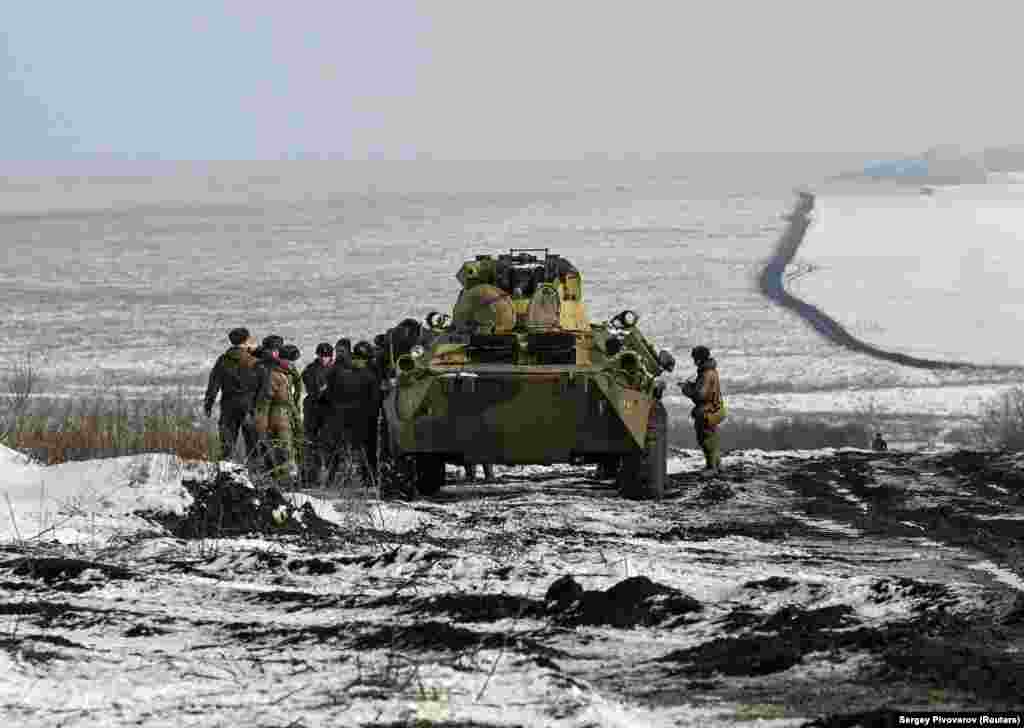 Russian soldiers stand next to a BTR-82 armored personnel carrier during drills at the Kuzminsky range on January 26.&nbsp;