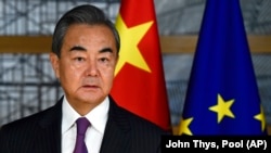 Министерот за надворешни работи на Кина, Ванг Ји, стои покрај знамињата на ЕУ и Кина