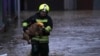 A firefighter evacuates a dog from a flooded area in northern Serb-dominated part of ethnically divided town of Mitrovica, Kosovo