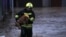 A firefighter evacuates a dog from a flooded area in northern Serb-dominated part of ethnically divided town of Mitrovica, Kosovo