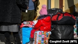 A háború miatt Ukrajnából Magyarországra menekülők várakoznak a beregsurányi polgármesteri hivatalnál kialakított segítségpontnál 2022. március 1-jén