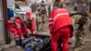Ukrainian medics remove the body of a Russian soldier after Kyiv's forces retook the village of Mala Rohan, east of Kharkiv, on March 30.